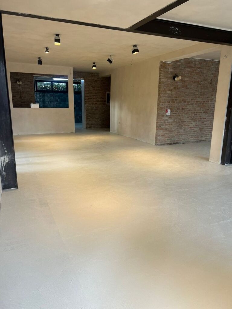 The dining room during the works: new floor, exposed brick and steel